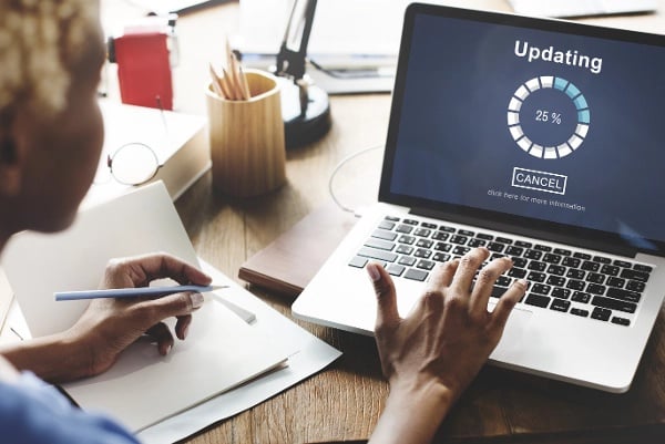 Woman updating software on laptop