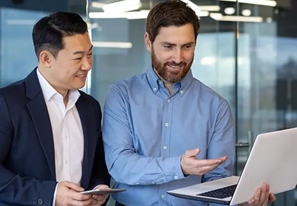 co-workers looking at laptop