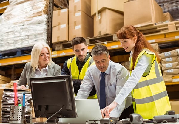 Procurement team looking at computer
