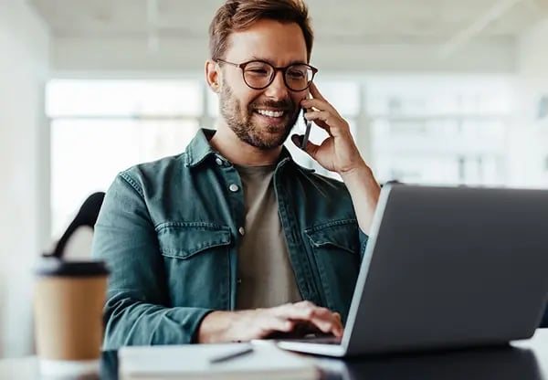 Man on phone and laptop
