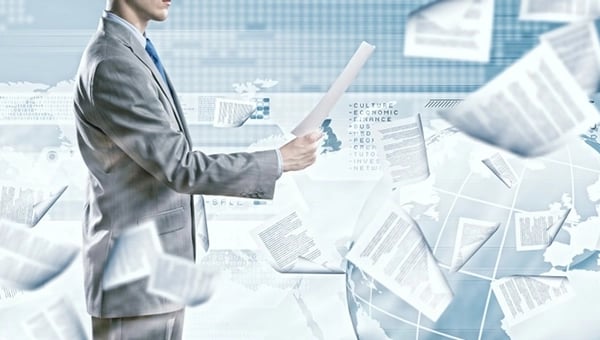 Man surrounded by paper documents