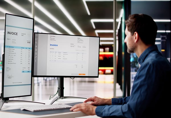 man looking at invoice software