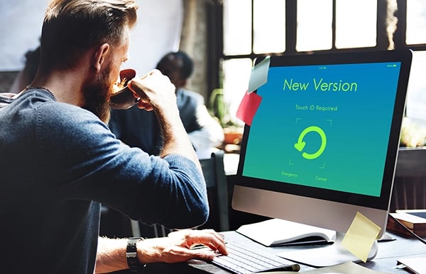 Man viewing software updates on computer