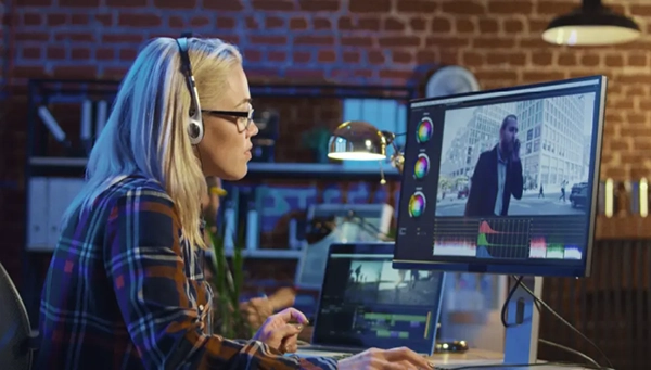 Young woman working with video on computer