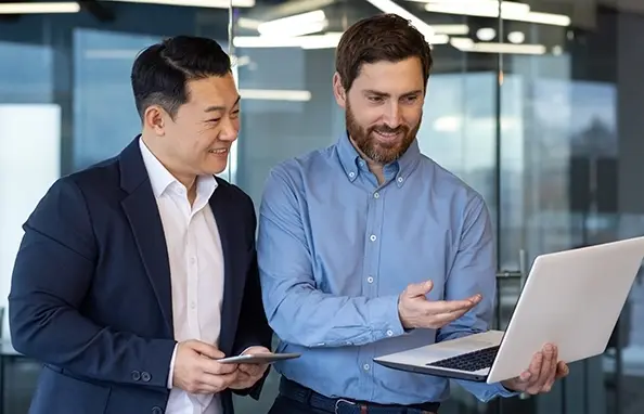 Two colleagues looking at laptop